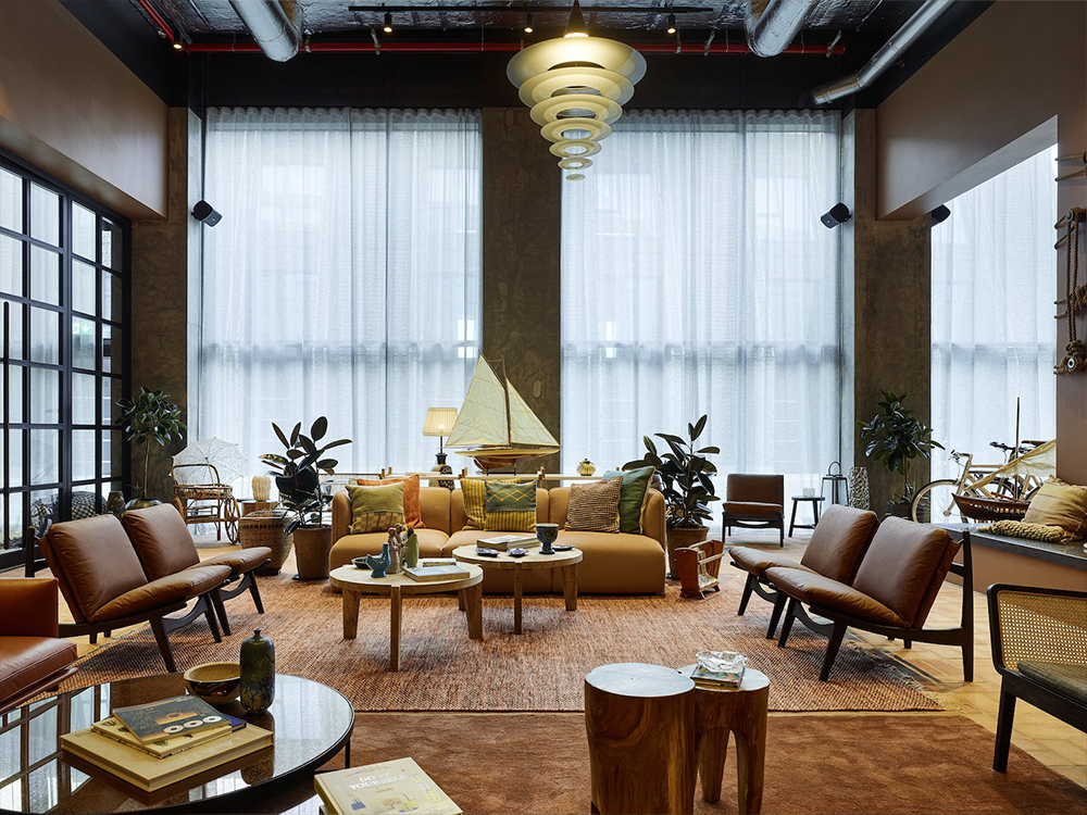 Modern living room with handcrafted rug, leather sofas, and Massimo Copenhagen decor