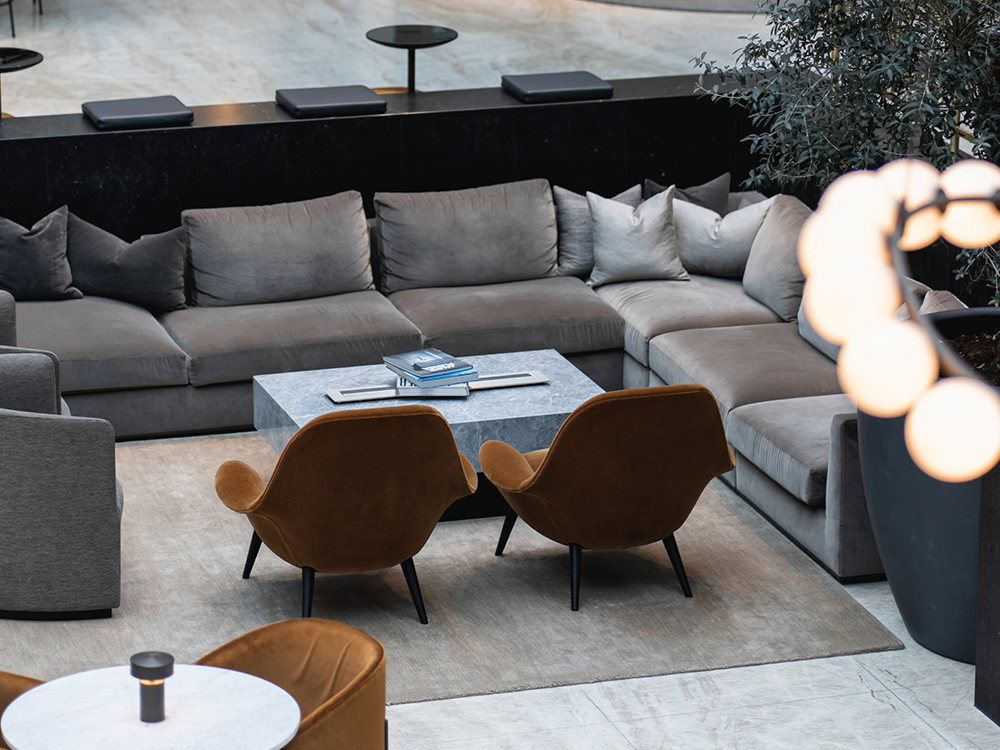 Modern Massimo Copenhagen living space with velvet sofa, armchairs, and luxury rug